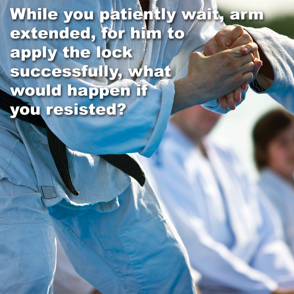 While you patiently wait, arm extended, for him to apply the lock successfully, what would happen if you resisted? image